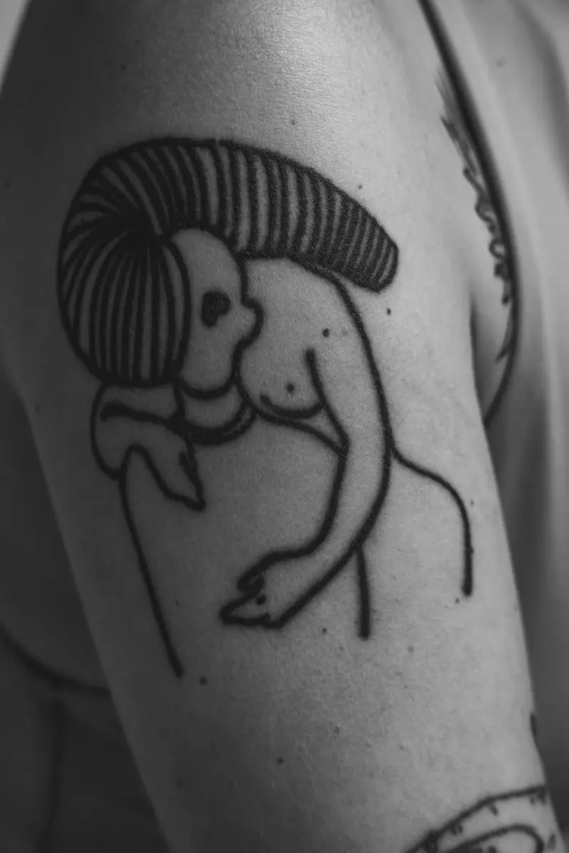 Bold black outline of a figure with sweeping hair on an upper arm