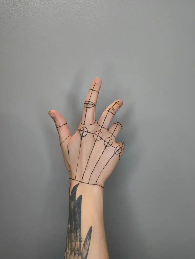 Fine-line drawing of hand bones traced over the back of a raised hand